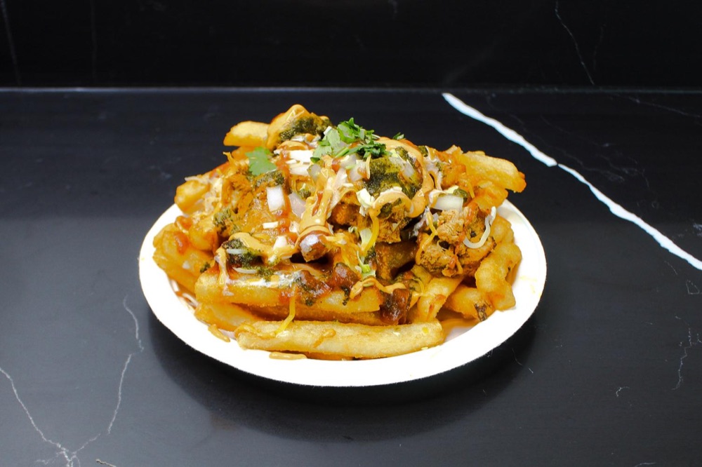 Loaded fries topped with chicken tikka and chutneys